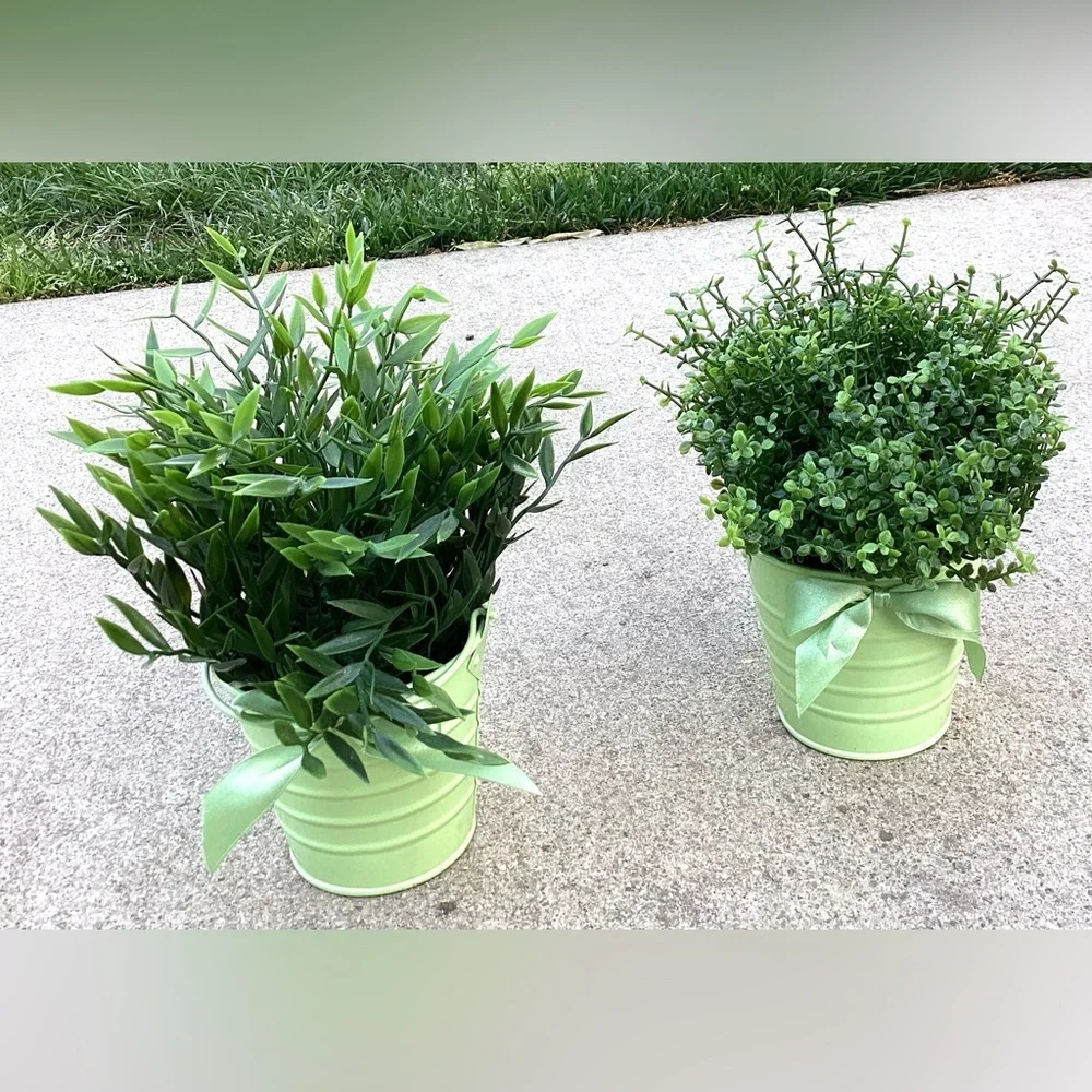 2 decorative faux green plants with pretty pots